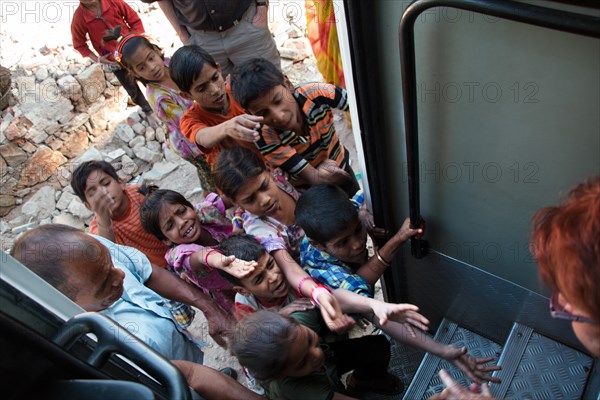 Children begging at a tourist bus