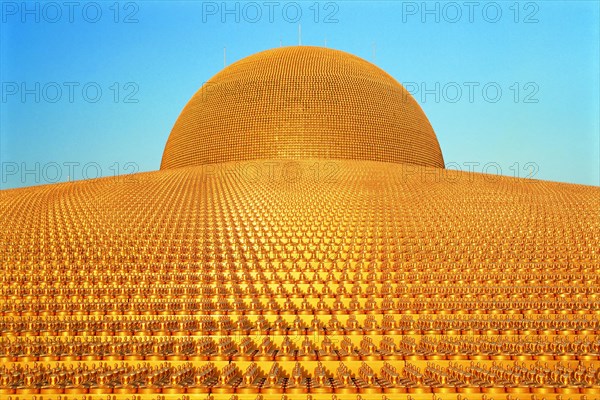 Buddhist temple Wat Phra Dhammakaya with golden Dhammakaya Buddha statues on the Chedi