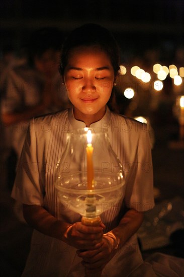 Young woman holding candle