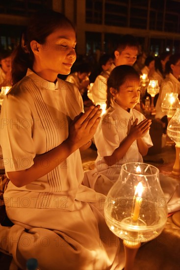 Young woman and child praying