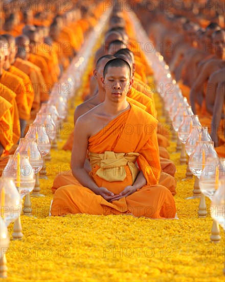 Monks sitting in a row meditating