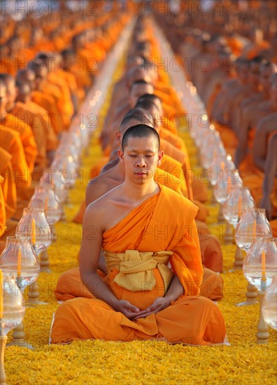 Monks sitting in a row meditating