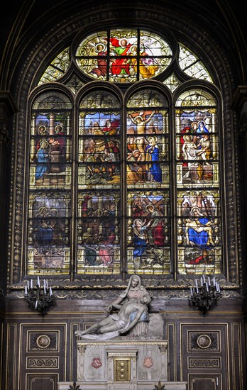 Pieta in front of stained glass window in the church of Saint Eustache