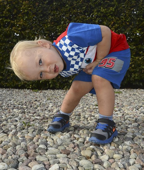 Little blond boy in colorful outfit