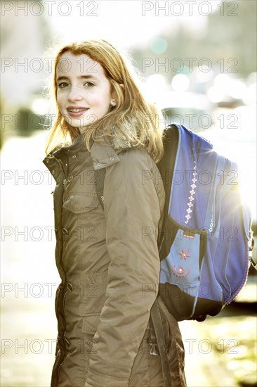 School girl with school bag on her way to school