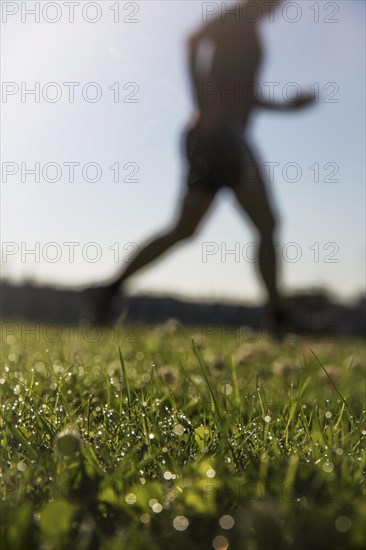 Jogger running in grass