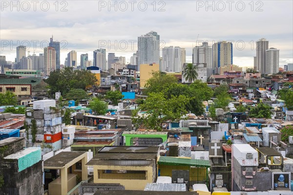 Towers of Makati City financial district above Pasay City Cemetery