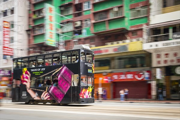 Double-decker tram passing on Hennessy Road