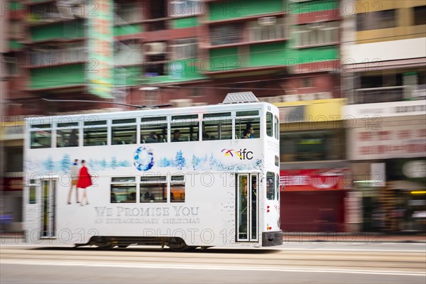 Double-decker tram passing on Hennessy Road