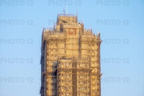 Skyscraper covered with bamboo scaffolding