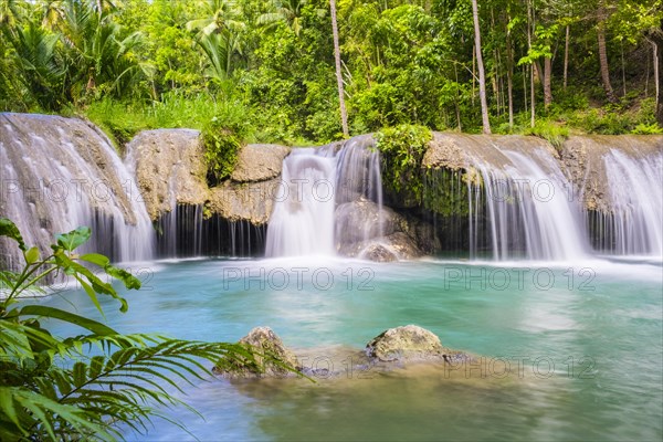 Cambugahay Falls surrounded by jungle foliage