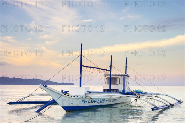Bangka outrigger boat at sunrise on White Beach