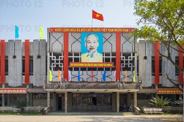 Portrait of Ho Chi Minh and Vietnamese flag on a government building