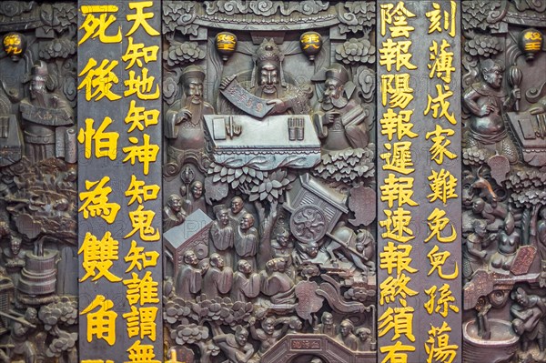 Wood carvings and Chinese characters inside of the Jade Emperor Pagoda