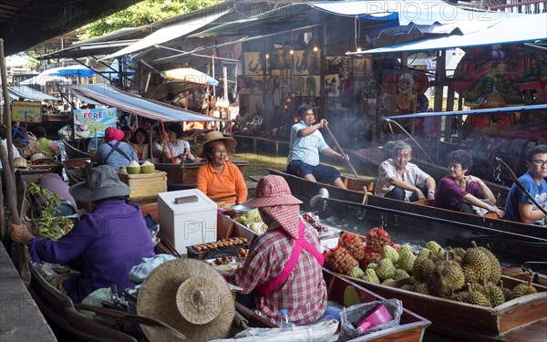 Floating Market with boats and sellers on a canal or Khlong