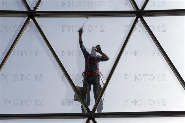 Painter painting the steel tube construction of a glass dome