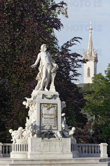 Mozart monument in Burggarten with Augustinian Church
