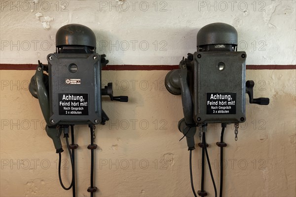 Two telephones in a bunker from the 2nd World War with inscription