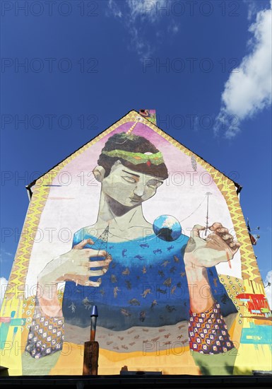 Surreal figure holding globe