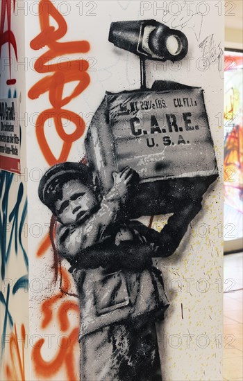 Young boy carrying US-care package with surveillance camera