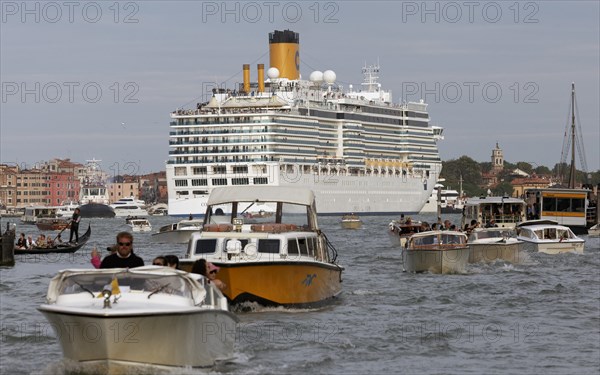 Heavy boat traffic with cruise ship in the lagoon in front of San Marco