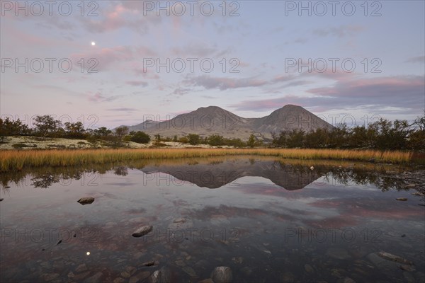 The peaks of the Stygghoin or Stygghoin mountain group reflected in a small lake