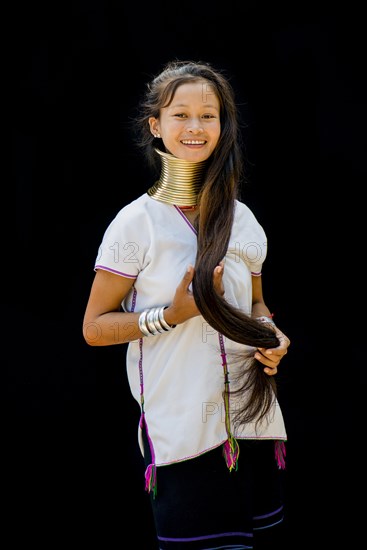 Young Kayan hill tribe woman doing her hair