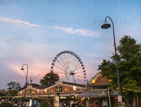 Asiatique Riverfront promenade with Ferris wheel at sunset