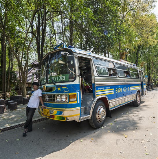 Driver leaning on his bus