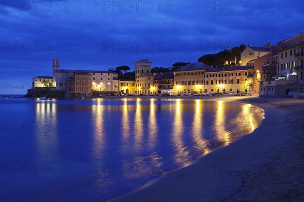 Town beach in the bay Baia del Silenzio with Chiesa di San Nicolo church