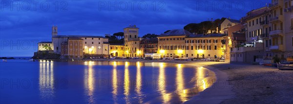 Town beach in the bay Baia del Silenzio with Chiesa di San Nicolo church