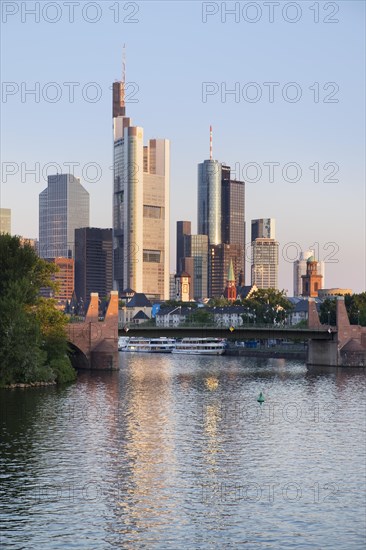 Old bridge over the Main and high-rise buildings in the financial district in the morning light