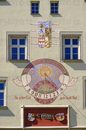 Coat of arms and sundial on facade
