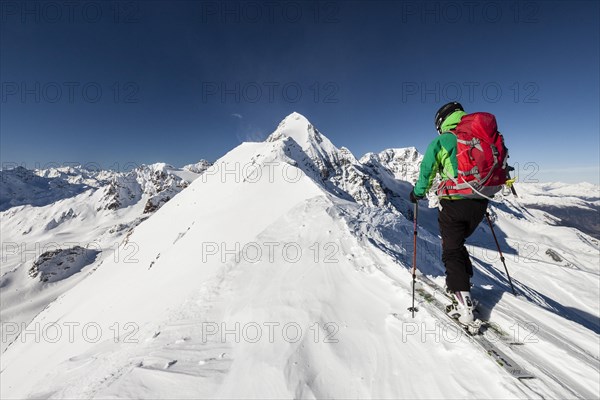 Ski tourer ascending the Suldenspitz behind the Konig and Ortler