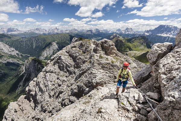 Mountaineer ascending to Cima d'Auta on the Via Ferrata Paolin Piccolin at Colmean