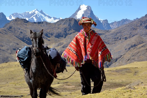 Indio mountain guide with colorful poncho and horse