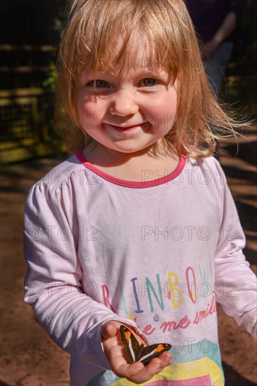 Little girl with a butterfly on her hand