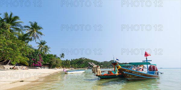 Longtail boats on the sandy beach