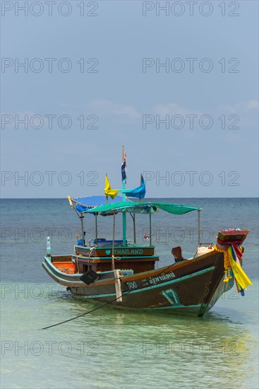 Longtail boat in the turquoise sea