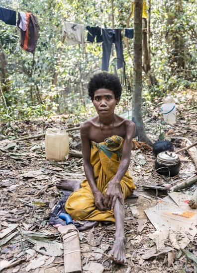 Woman of the Orang Asil tribe sitting in the jungle