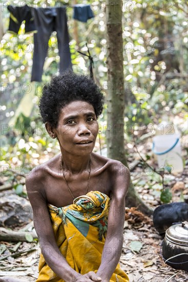 Woman of the Orang Asil tribe sitting in the jungle