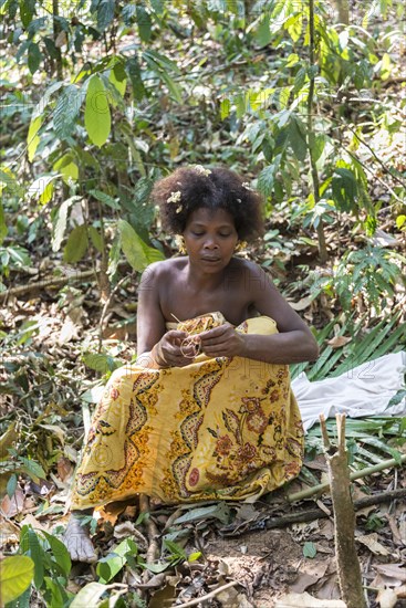 Woman of the Orang Asil tribe sitting in the jungle