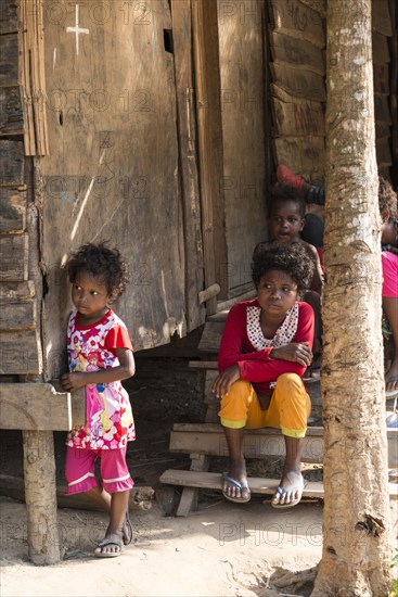 Two young girls in front of a house