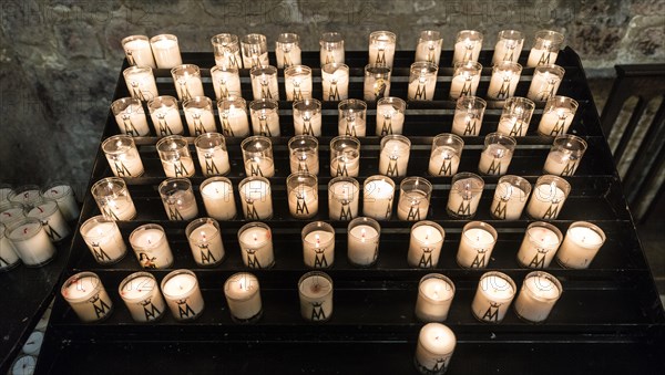 Burning sacrificial candles in a church