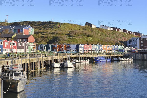 Inland harbor with boats and colorful lobster shacks