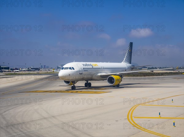 Vueling airliner rolling on the apron of the airport