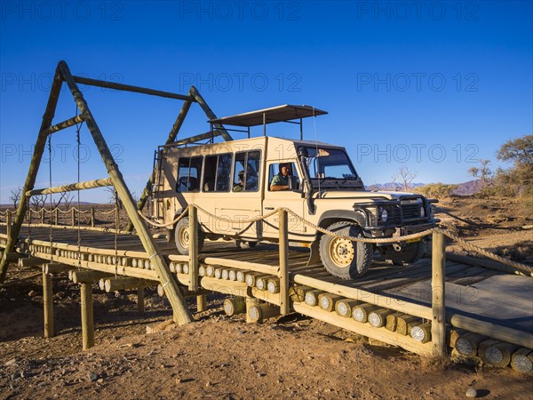 Land Rover crossing a wooden bridge in the Kulala Wilderness Reserve on the edge of the Namib Desert