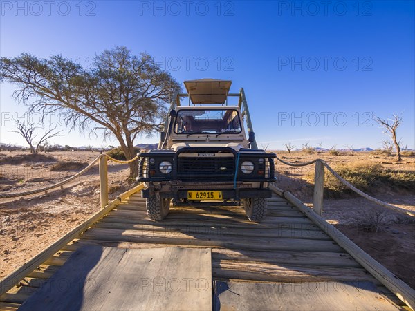 Land Rover crossing a wooden bridge in the Kulala Wilderness Reserve on the edge of the Namib Desert