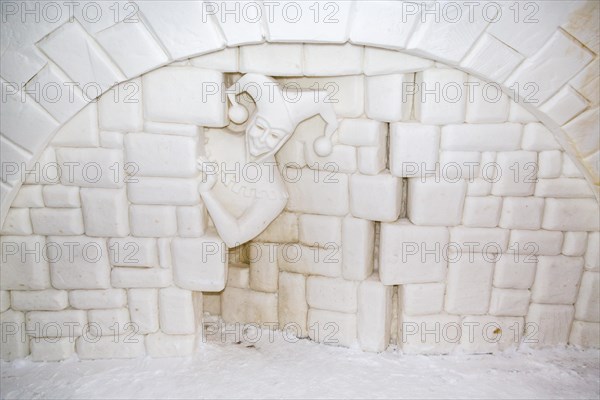 Wall relief of a jester in the ice hotel