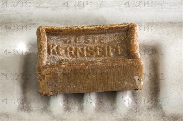 Piece of curd soap on an old sink in a former factory